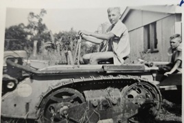 Charles on the tractor pulling the trough