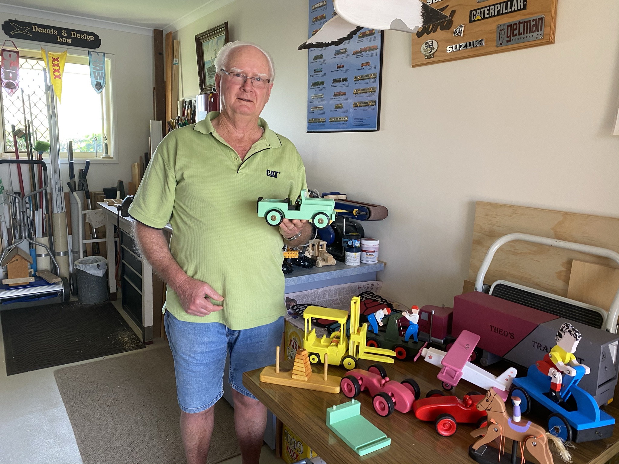 Dennis with toys in his workshop.JPEG Dennis with toys in his workshop.JPEG