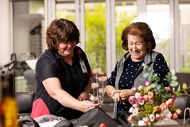 Two ladies looking through independent living equipment  Two ladies looking through independent living equipment