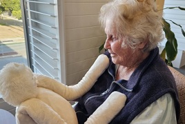 Seaton Place resident with cuddly companion HUG Seaton Place resident with cuddly companion HUG