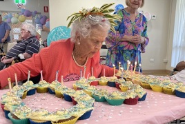 Lillian blowing out her 100th birthday candles