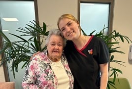 An elderly resident with young Bolton Clarke staff member, smiling