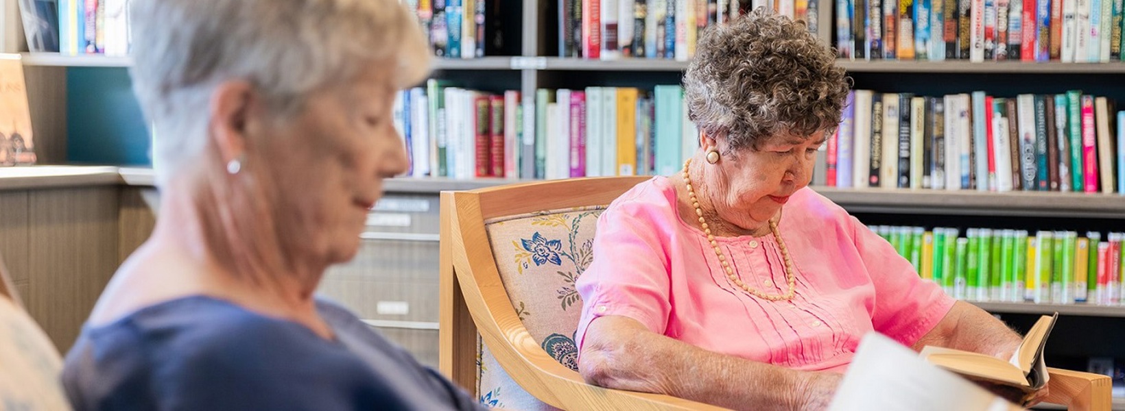 Two elderly females reading peacefully  Two elderly females reading peacefully