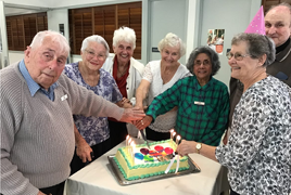 The original residents cutting the cake for the Birthday Bash 