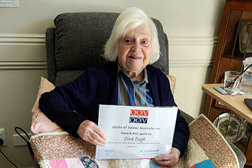 Olive Pugh with her Quilt of Valour and Certificate