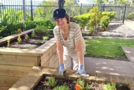 Resident Dianna tending to plants in the Buderim Views Goodness Garden.